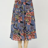 Woman wearing a mid-length printed skirt with fluid movement and refined drape