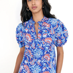printed blue short sleeve top modeled against white background