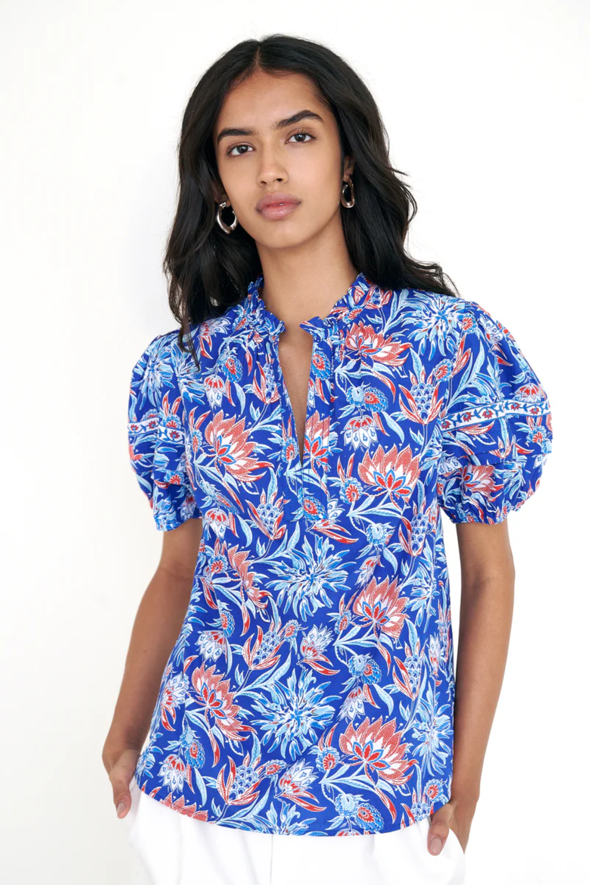 printed blue short sleeve top modeled against white background