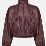 A cropped, long-sleeve jacket in a glossy burgundy faux leather material, featuring a mock neck, front zipper, and elasticized hem and cuffs, shown against a plain light gray background.