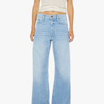 Person wearing light blue jeans and a white tank top on a white background