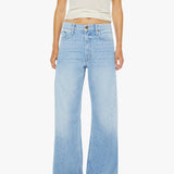 Person wearing light blue jeans and a white tank top on a white background