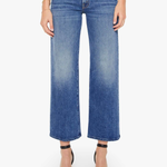 Blue jeans worn by a person on a white background