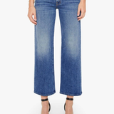 Blue jeans worn by a person on a white background