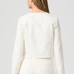 Person wearing a white outfit with a plain background