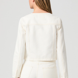 Person wearing a white outfit with a plain background