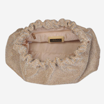 A beige and gold rhinestone-embellished clutch bag with a scalloped edge, shown from a top-down view on a light gray background.