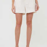 Person wearing white shorts on a plain background