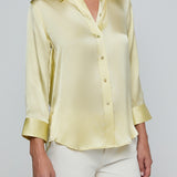 Light yellow satin shirt worn by a person on a plain background