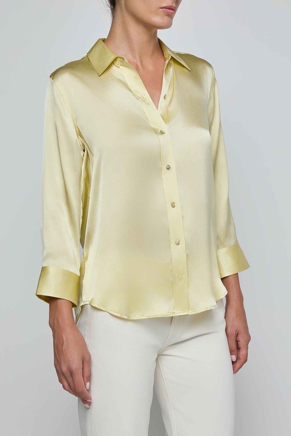 Light yellow satin shirt worn by a person on a plain background