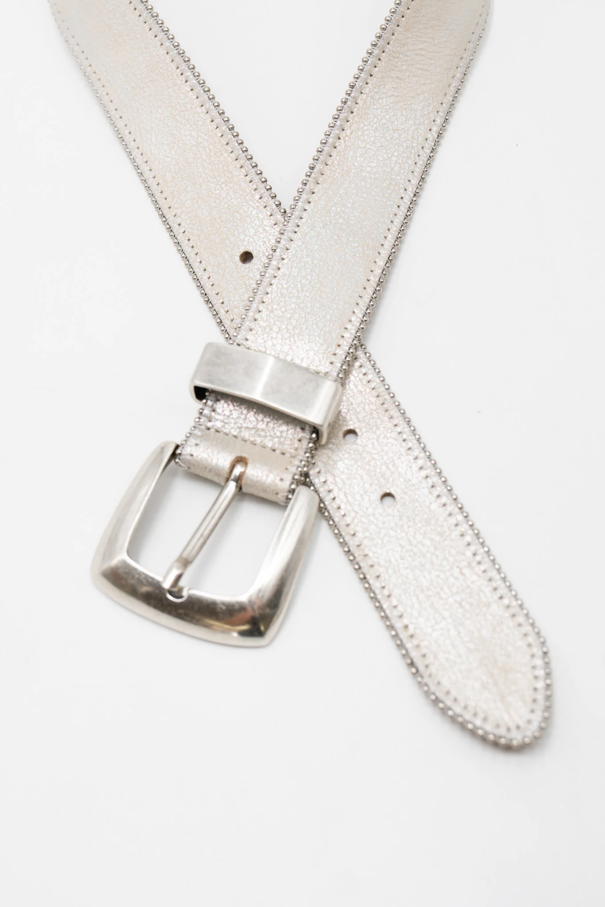 Silver belt with a metallic buckle on a white background