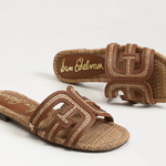 Brown sandals with woven design and visible brand name on a white background