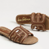 Brown sandals with woven design and visible brand name on a white background