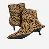 A pair of pointed-toe ankle boots with a tan and black leopard print pattern and kitten heels, shown against a plain light gray background.