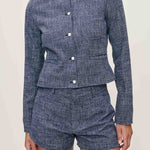 Blue textured set with jacket and shorts on a neutral background