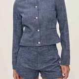 Blue textured set with jacket and shorts on a neutral background