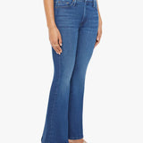 Woman wearing mid-wash flared jeans with a slim fit through the hip and gentle flare at the hem.