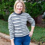 Long sleeve striped sweater with a round neckline.