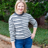 Long sleeve striped sweater with a round neckline.