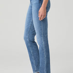 Woman wearing mid-wash straight-leg jeans with a streamlined, classic silhouette.