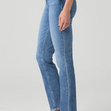 Woman wearing mid-wash straight-leg jeans with a streamlined, classic silhouette.