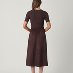 Woman wearing a brown dress on a white background