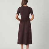Woman wearing a brown dress on a white background