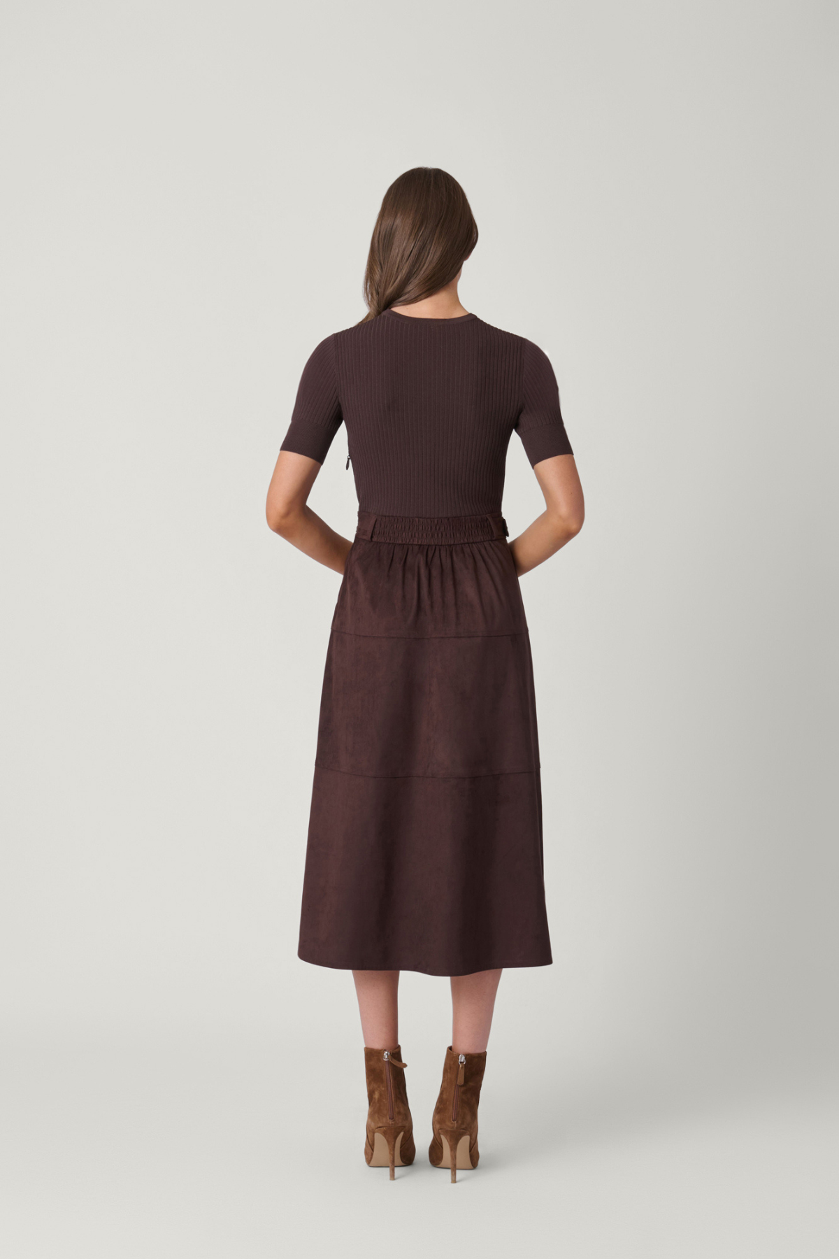 Woman wearing a brown dress on a white background