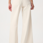 A person shown from the back wearing off-white wide-leg pants with a beige top and beige flat shoes, photographed against a plain light background.