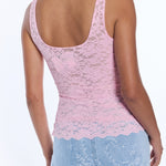 back of woman in pink lace tank top on white background 