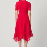 Elegant red dress with a fluid silhouette, styled for an evening setting.