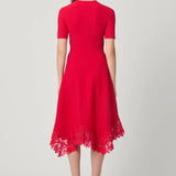Elegant red dress with a fluid silhouette, styled for an evening setting.