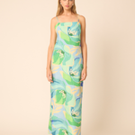 woman in printed maxi dress on tan background 