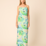 woman in printed maxi dress on tan background 