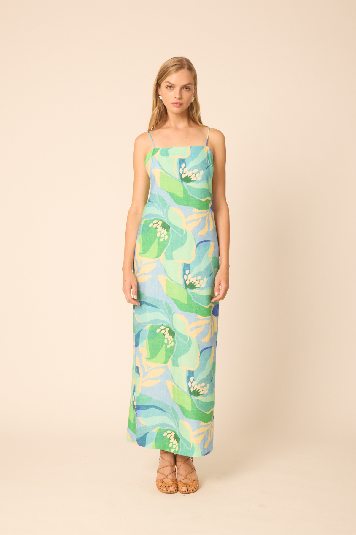 woman in printed maxi dress on tan background 