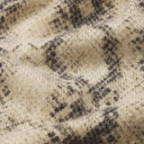 Cashmere cardigan with subtle snake pattern, styled with dark denim