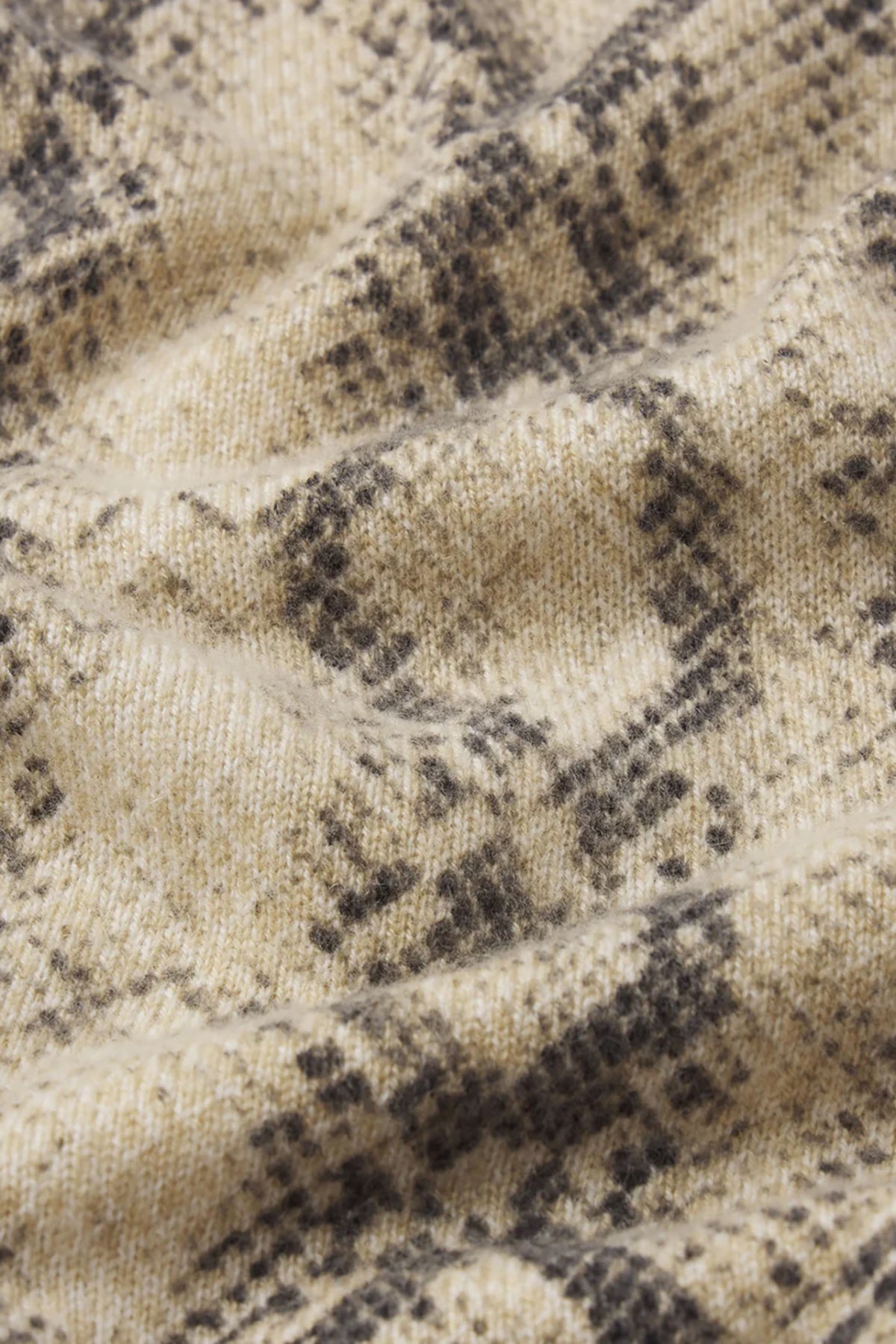 Cashmere cardigan with subtle snake pattern, styled with dark denim