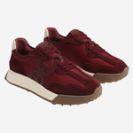 A pair of low-top sneakers in burgundy suede and mesh, featuring a thick cream midsole and a brown gum outsole, shown against a light gray background.