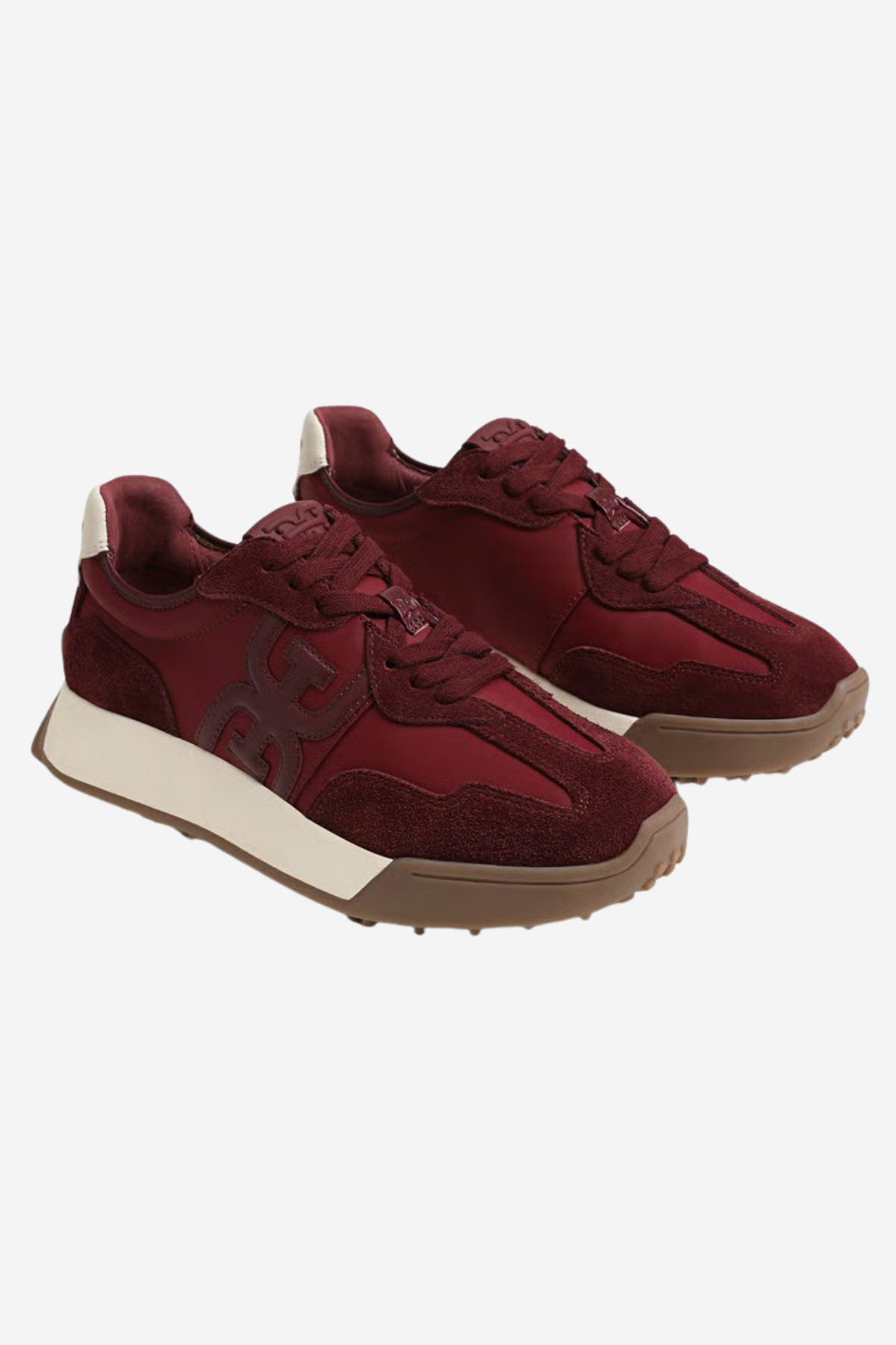 A pair of low-top sneakers in burgundy suede and mesh, featuring a thick cream midsole and a brown gum outsole, shown against a light gray background.