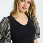 Black short-sleeve top with a clean neckline and soft drape