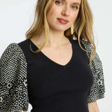 Black short-sleeve top with a clean neckline and soft drape
