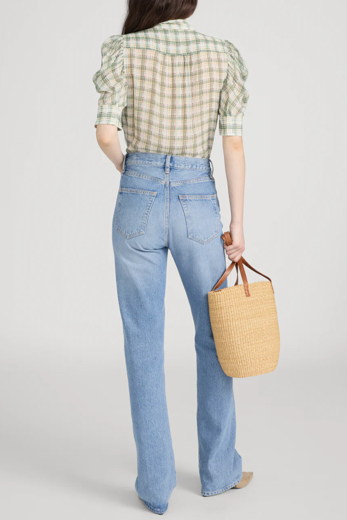 Model wearing a light green printed blouse with a relaxed silhouette