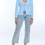 woman in light blue blazer and denim on white background