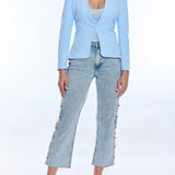 woman in light blue blazer and denim on white background