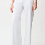 White pants with gold buttons worn by a person on a white background