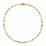 A gold tennis necklace featuring small oval-cut clear gemstones set in a yellow gold chain, displayed on a clean white background.