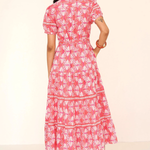 Woman wearing a pink floral dress on a white background