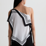 Model wearing a contemporary sleeveless printed top with a relaxed, flattering silhouette.