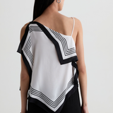 Model wearing a contemporary sleeveless printed top with a relaxed, flattering silhouette.