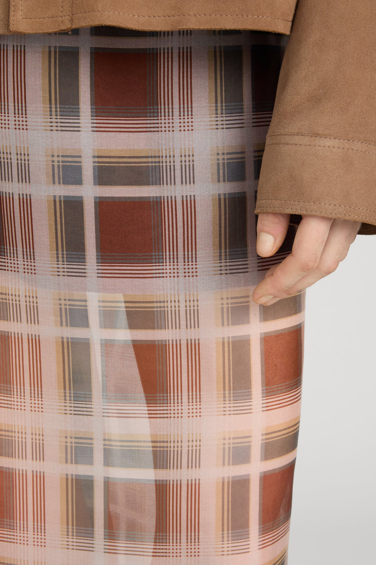 Plaid skirt with a brown jacket on a white background